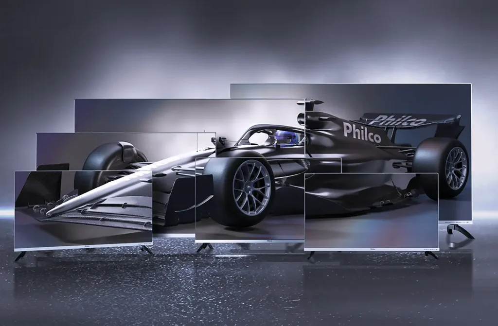 Carro de Fórmula 1 preto com logo Philco exibido em múltiplas telas de smart TVs Philco, representando tecnologia, inovação e experiência imersiva.