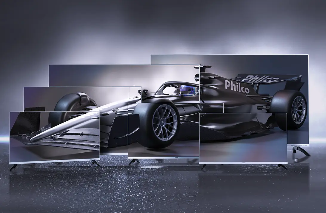 Carro de Fórmula 1 preto com logo Philco exibido em múltiplas telas de smart TVs Philco, representando tecnologia, inovação e experiência imersiva.